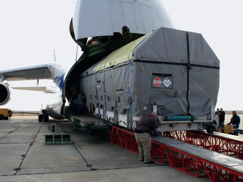 Large cargo being loaded into a cargo plane
