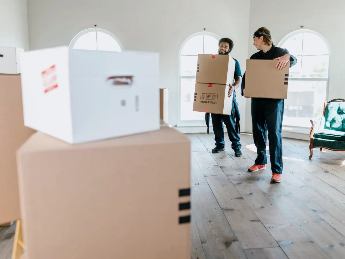 Movers loading packed household goods into a truck