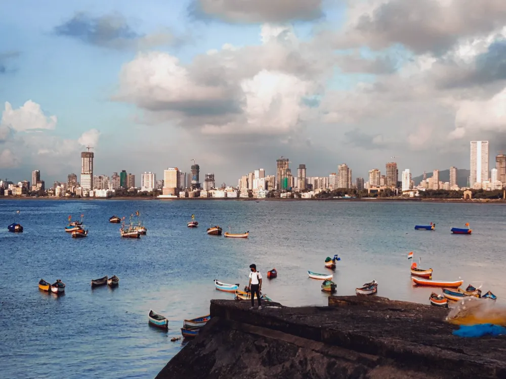 Mumbai skyline across the bay, with boats in the water