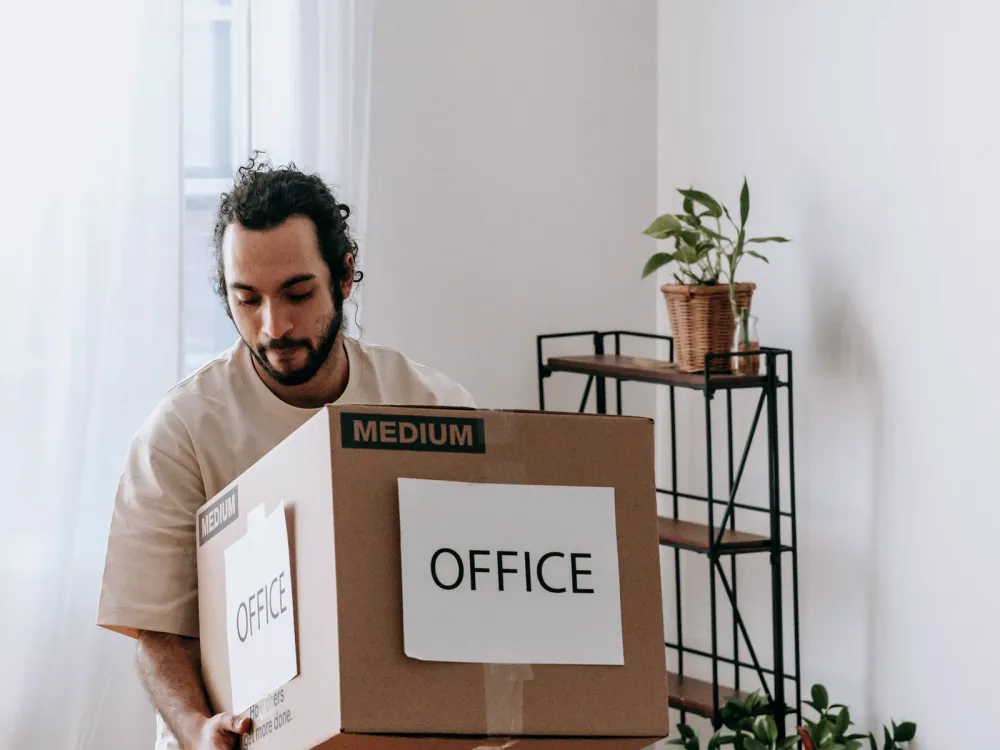 Man carrying a carton labelled office
